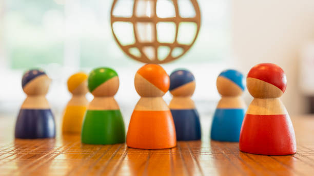 istock Multi-colored models stand together and discuss their work. Diverse group of stylish people standing together. Society or population, social diversity concepts. 1565235567
