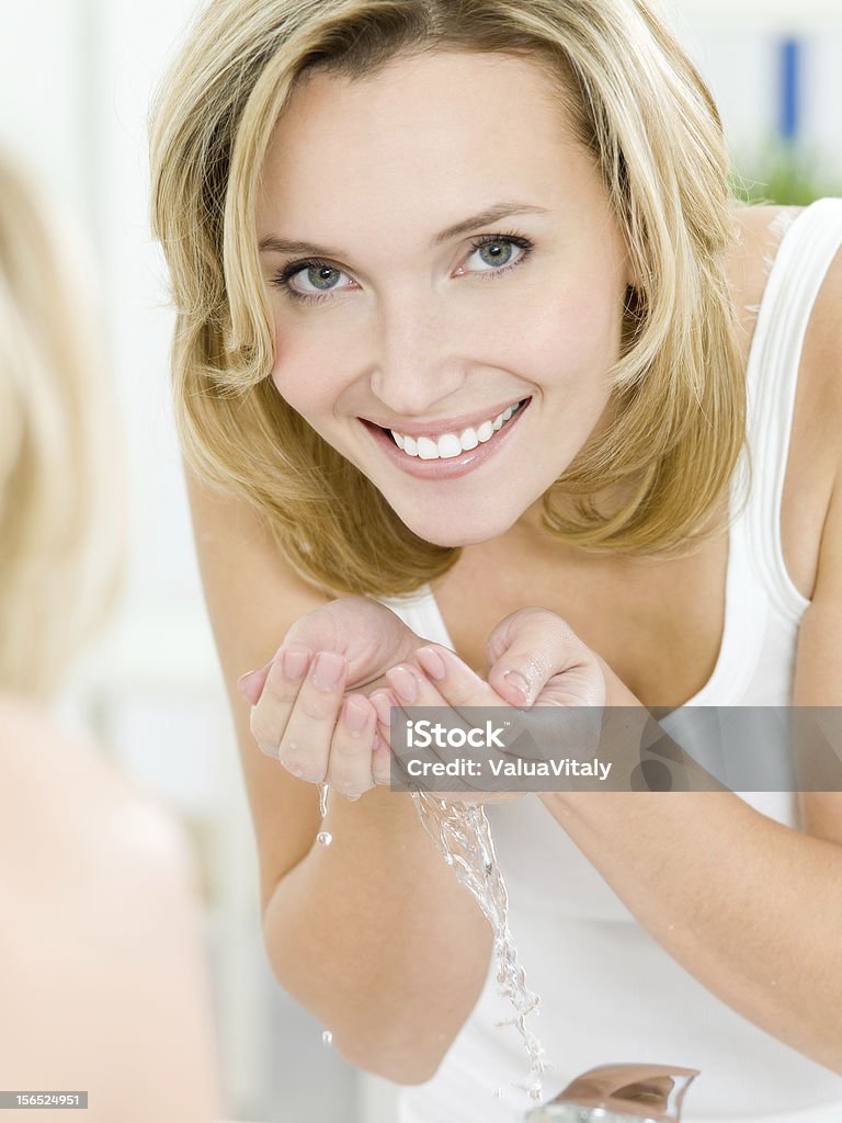 woman washing face Beautiful woman washing face - indoors Beauty Stock Photo