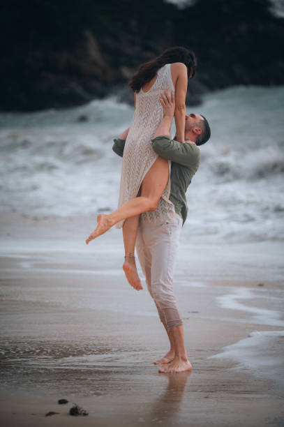 istock Young couple having fun on the beach 1565260163