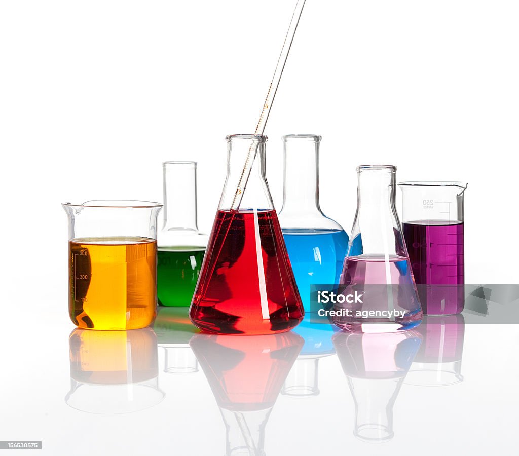 Various laboratory flasks with a colored liqiuds Various laboratory flasks with a colored reagents, isolated Drinking Glass Stock Photo