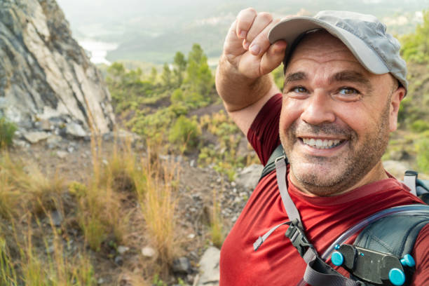 istock Smiling happy hiker takes a selfie outdoors freedom 1565317783