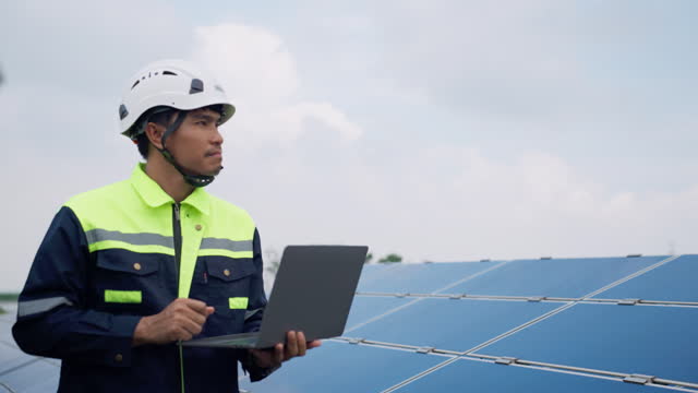 Empowering Renewable Energy: Engineer Conducts Vital Maintenance on Solar Panel Boards,Efficiency and Sustainability: Technician Ensures Solar Panel Boards are in Prime Condition.