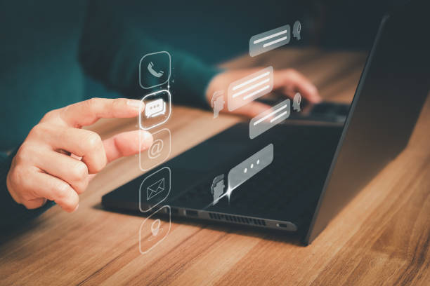 istock Client use a computer laptop with a virtual screen for apps chat, phone, email, addresses, and map icons. Customer service support hotline contacts us with the people connection technology concept. 1565349744