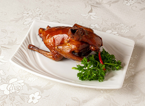 braised bbq pigeon served dish isolated on background top view of hong kong chinese food