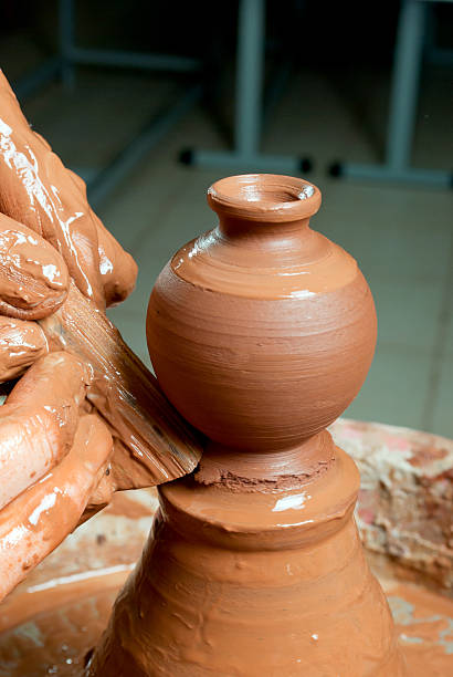 istock hands of a potter, creating an earthen jar 156536573