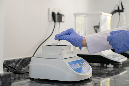 A biologist conducts genetic and scientific research for agricultural vegetables in the laboratory using scientific equipment