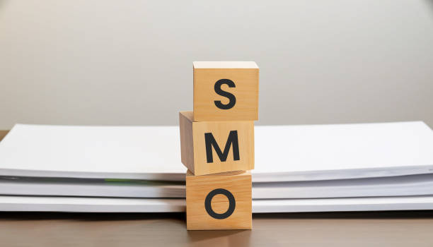 istock SMO sign on wooden blocks with documents behind on white background business concepts 1565403856