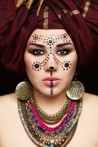 Portrait of young beautiful woman with traditional Berber face paint and turban