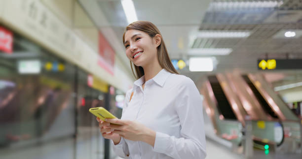 istock woman use phone at station 1565440051