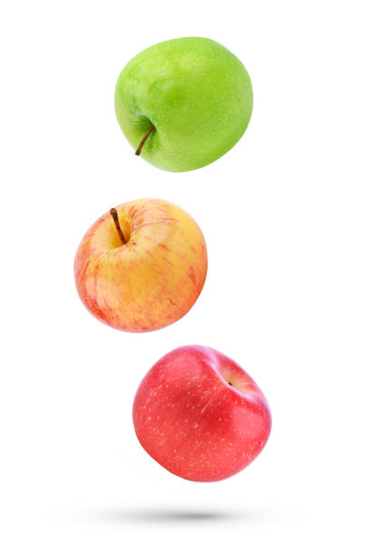 istock Whole fresh apple falling in the air isolated on white 1565473505