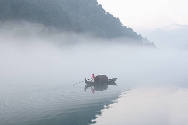 fishermen in the fog preparing to fish stock photo