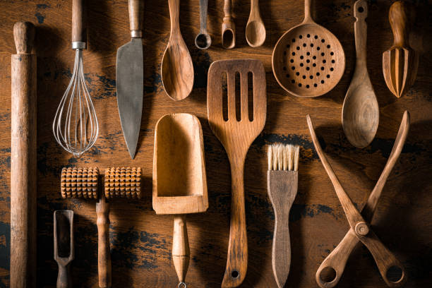 istock Wooden cutlery and kitchenware arrangement on rustic wood table board 1565487107