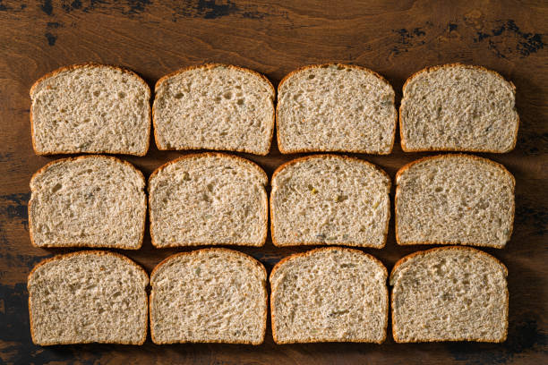 Sliced loaf of bread slices in a row flat lay view patern bread backgrounds on wooden rustic table board