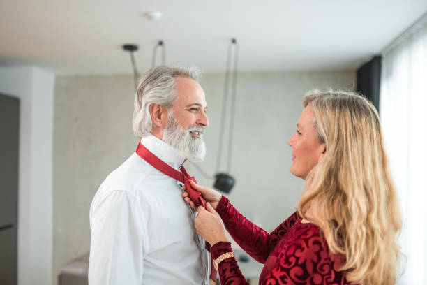 istock Senior Caucasian Male Dressing Up With Wife's Help 1565502016
