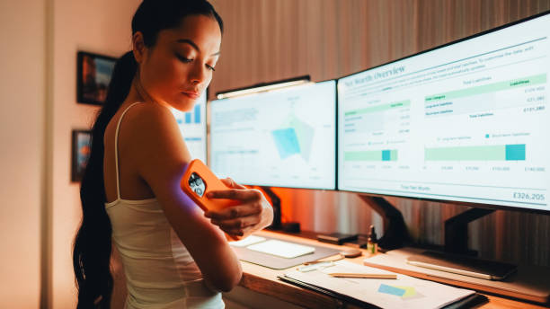 Day in the life of woman with diabetes working from home stock photo