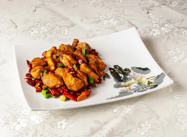 Sichuan Spicy Chicken served dish isolated on background top view of hong kong chinese food