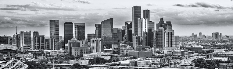 The skyline of Houston Texas cropped in panoramic and processed in black and white using high contrast for effect.