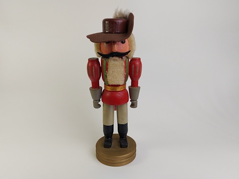 A closeup of a toy soldier  with a mustache on a white background
