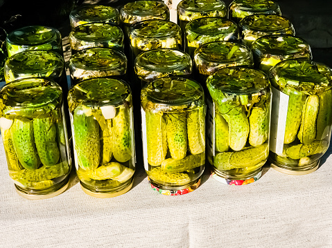 The process of pickling cucumbers for the winter in glass jars. Cucumbers and spices for pickling are laid out in jars. Preservation is ready.