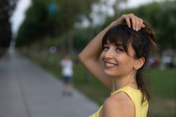 Portrait of young smiling woman in park