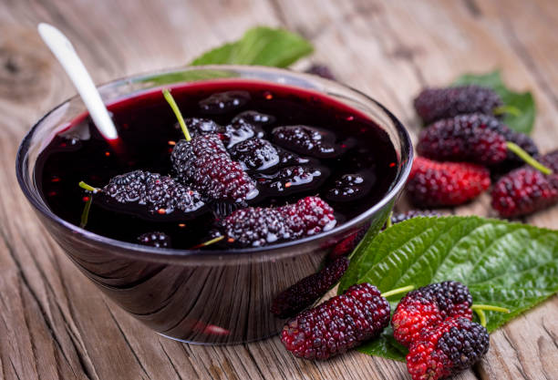 istock Domestic fresh mulberry jam on a rustic wooden board 1565613230