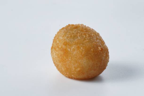 istock Close-up of a fried dough ball against a white background 1565655706