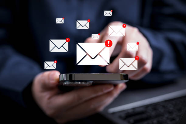 istock People with warning notification and spam message icon on mobile phone 1565670223