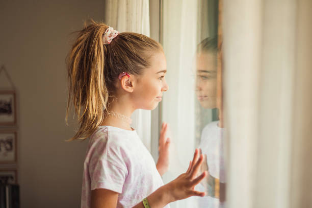 istock DEAF GIRL WITH HEARING AID 1565677370