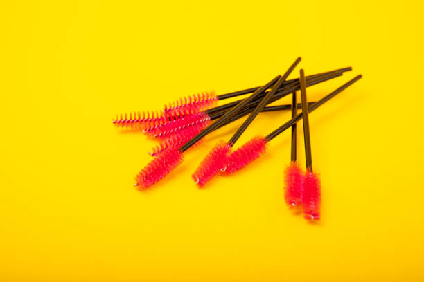 istock Brushes for eyelash extension on a background. Brush for combing eyelashes.brush for straightening eyelashes and eyebrows. 1565678941
