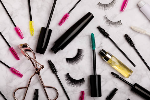 istock Composition with false eyelashes, mascara and eyelash brushes, eyelash curlers on a background. Makeup artist tools. Beauty concept. Makeup. Place for text. Place for copying. Flatley. MOCAP. 1565678959