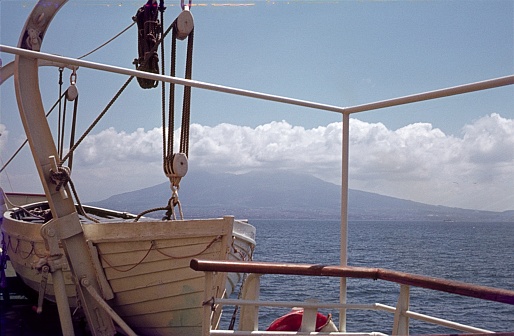 Gold of Naples, Italy, 1977. Cloud-draped Vesuvius seen from a ferry.