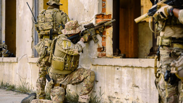 istock Smart teamwork of soldiers running forward and attacking enemy during military operation, Army soldiers in protective combat uniform, Soldiers with rifle, Soldiers with rifle on world war field 1565685567