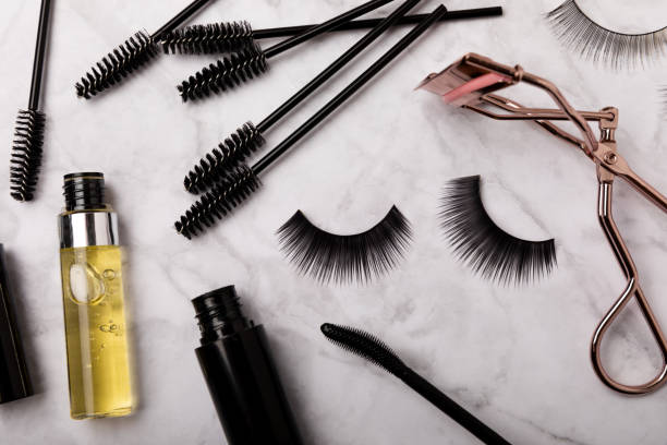 istock Composition with false eyelashes, mascara and eyelash brushes, eyelash curlers on a background. Makeup artist tools. Beauty concept. Makeup. Place for text. Place for copying. Flatley. MOCAP. 1565695015