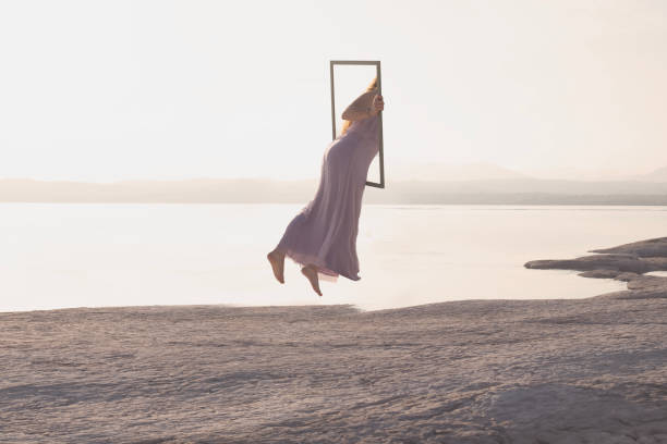 surreal journey of a woman who through a frame passes from the real world to the virtual one, concept of metaverse - imagination fantasy invisible women imagens e fotografias de stock