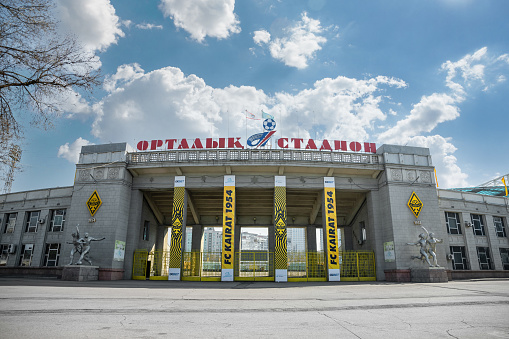 The main entrance of the central sports stadium of Almaty with the symbols of the football club Kairat. Almaty, Kazakhstan - March 23, 2023