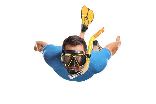Front view of a man in a suit snorkeling with fins and a mask isolated on white background