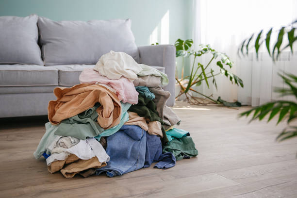 istock Pile of carelessly scattered clothes on floor. 1565714246