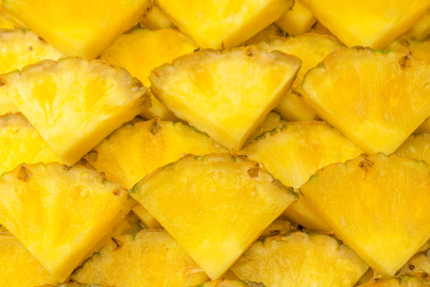 istock Pineapple juicy yellow slices as a background. 1565724971
