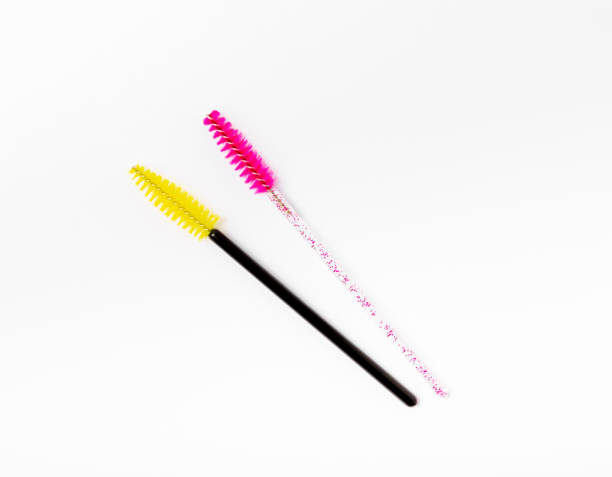 istock Pink eyelash extension brush isolated on white background. Brush for combing eyelashes.brush for straightening eyelashes and eyebrows. 1565740604