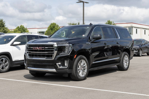 gmc yukon suv-ausstellung bei einem händler. gmc bietet den yukon in den modellen sle, slt, at4 und denali und denali ultimate an. - yukon stock-fotos und bilder