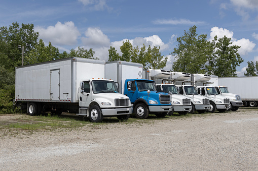 Indianapolis - July 21, 2023: Used Freightliner and International trucks for sale. Pre-owned semi tractor trailer trucks are in high demand.