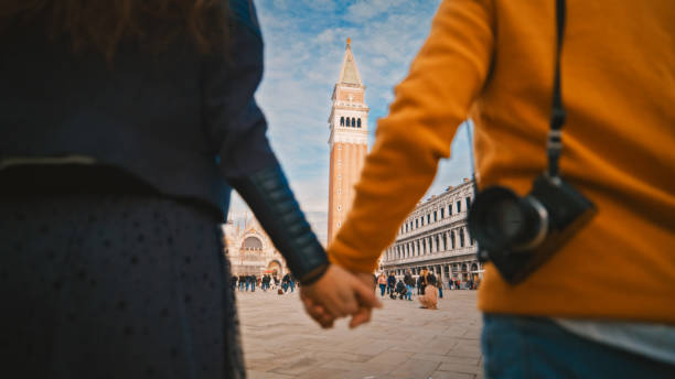 istock Heterosexual couple exploring at St. Mark's square during vacation 1565782323