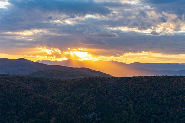 istock sunbeams light the clouds and hills on a clear day 1565788865