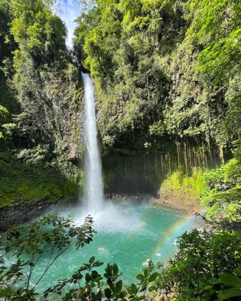 istock Beautiful and tranquil landscape featuring a waterfall cascading from a cliff 1565789251