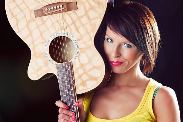 istock Young woman with accoustic guitar 156579146