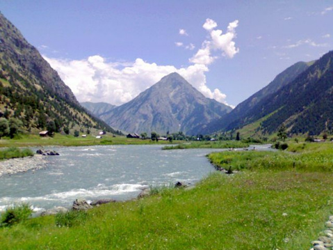Amazing view of the nature with the river and the huge mountains and the blue sky with clouds