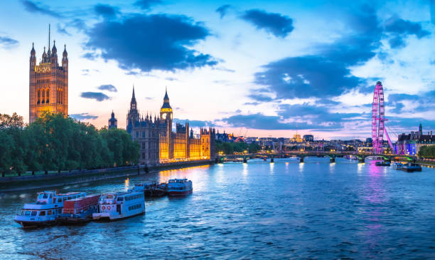 istock Bigh Ben and Thames riverfront sundown panoramic view in London 1565792990