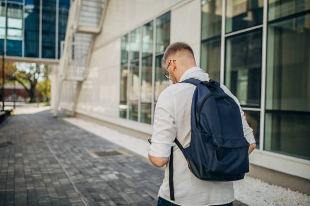 istock A young handsome businessman walking outside 1565803497