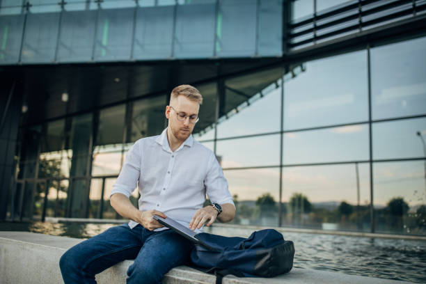 istock A young handsome businessman preparing for working outside 1565811965