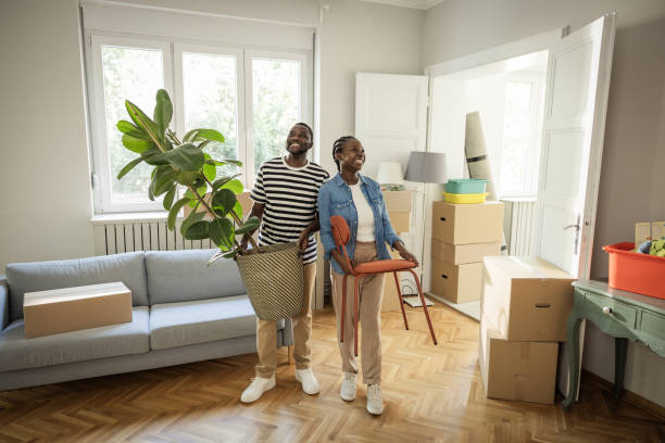 istock Young Couple with boxes Moving  in New Home 1565817253